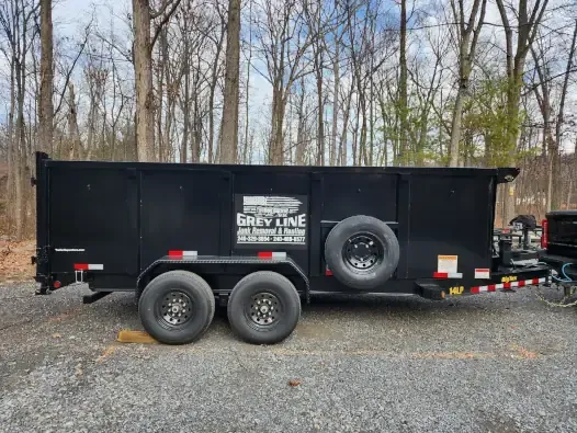 Grey Line Junk Removal truck near a finished job site